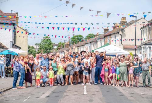 Group of neighbours in a street at a party